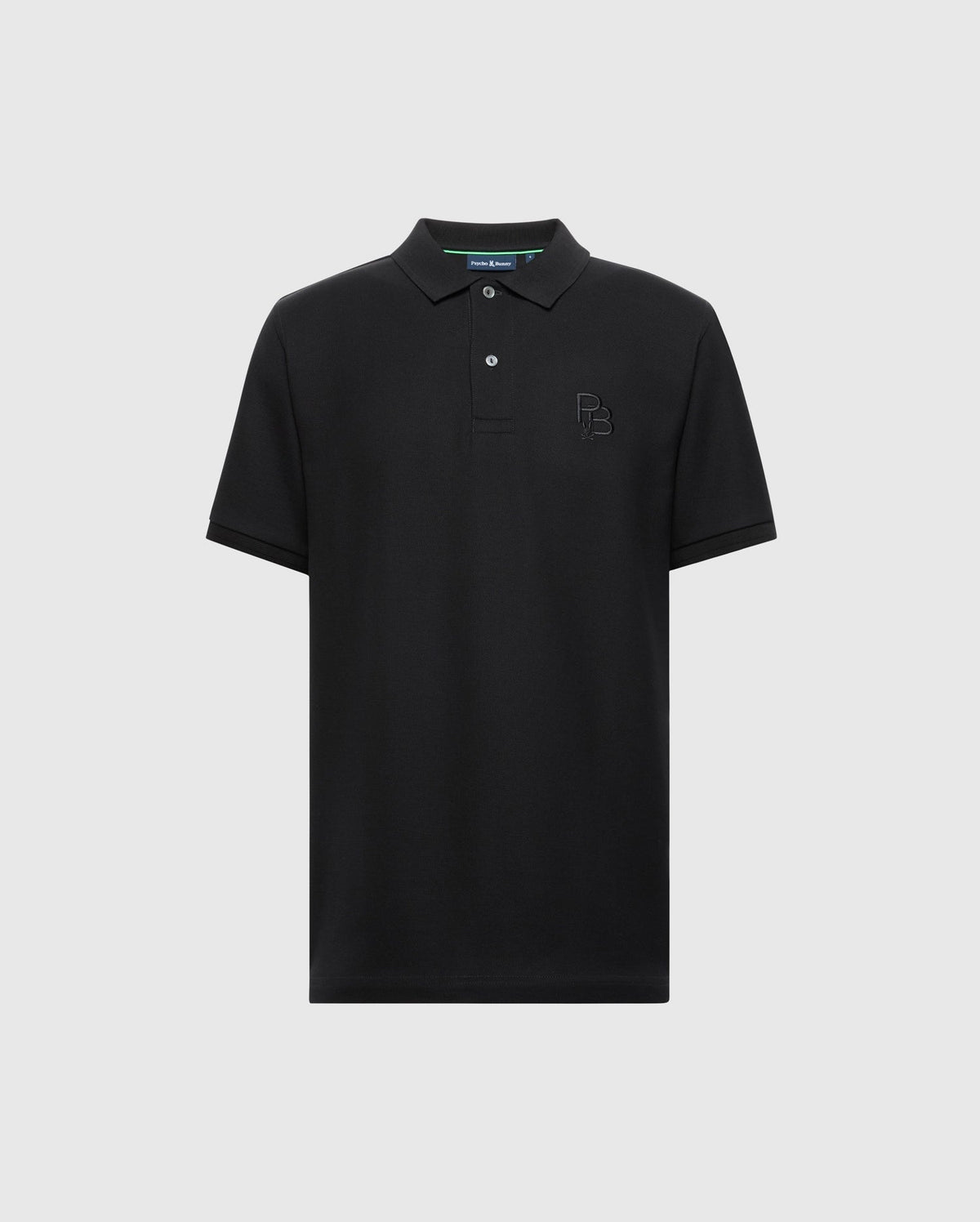 The Psycho Bunny MENS NICHOLSON RIB COLLAR PIQUE POLO - B6K401F200 is crafted from soft Pima cotton and features a small embroidered logo on the chest, short sleeves, and a traditional collar with a two-button placket. Its simple elegance is highlighted against a light grey background.