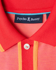 Close-up of the *Mens Woodway Oxford Polo - B6K405C200*, a red and orange collared shirt from Psycho Bunny. The label "Psycho Bunny" is attached to the inside of the collar. Made from a Pima cotton-blend, it features a classic two-button placket and a white button that contrasts with the vibrant fabric colors.