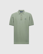 The MENS NEW CASTLE PIQUE POLO - B6K487F200 from Psycho Bunny is a green Pima cotton polo with short sleeves, contrast detailing, white-edged collar, and two buttons. This slim-fit shirt features a small embroidered rabbit logo on the left chest area.