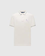 The Psycho Bunny MENS ELLIOT PIQUE POLO - B6K505F200 is a white Pima cotton shirt with short sleeves, featuring a collar, three buttons, subtle dark trim on the collar and sleeves, a small embroidered logo on the chest, all against a plain light gray background.