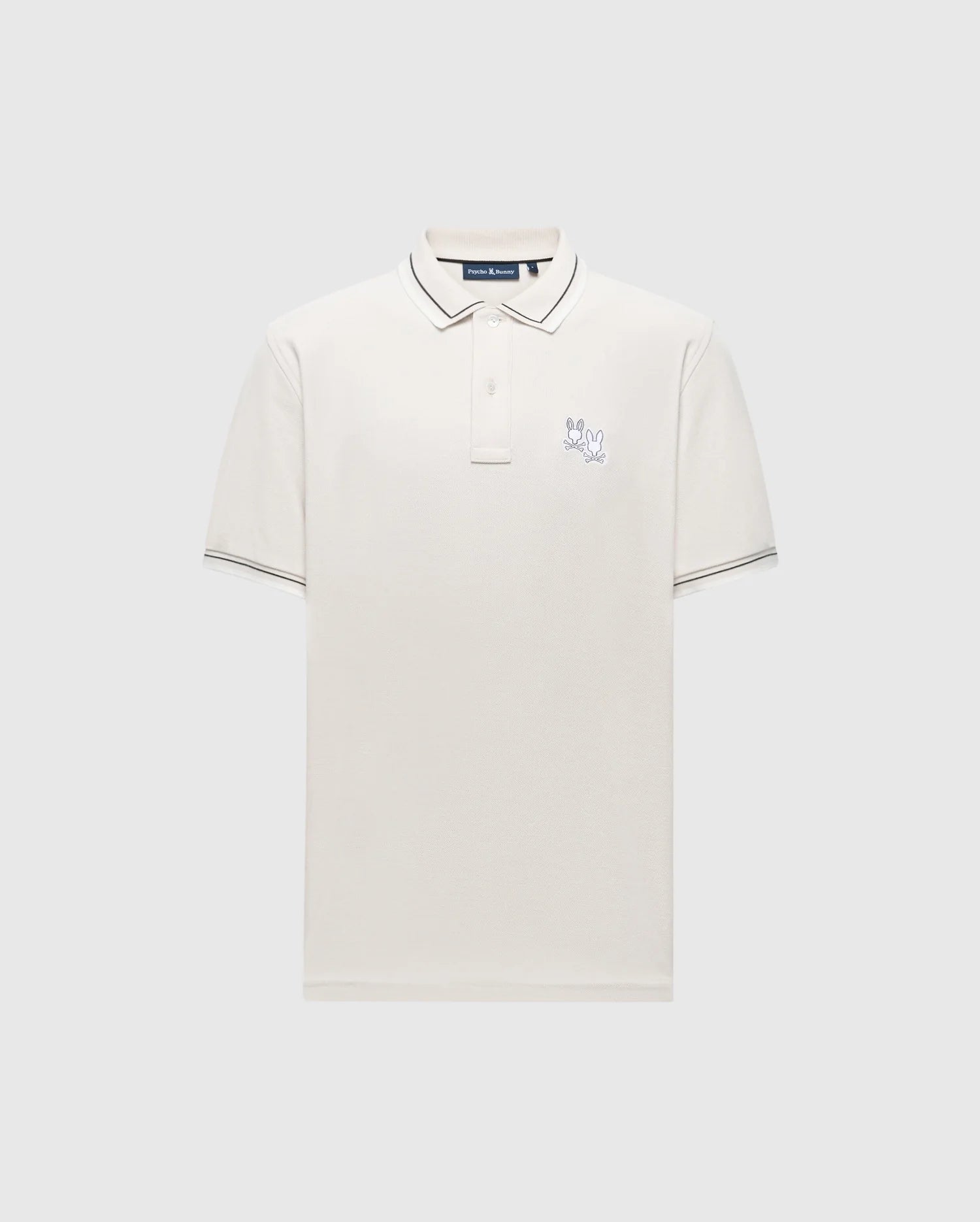 The Psycho Bunny MENS ELLIOT PIQUE POLO - B6K505F200 is a white Pima cotton shirt with short sleeves, featuring a collar, three buttons, subtle dark trim on the collar and sleeves, a small embroidered logo on the chest, all against a plain light gray background.