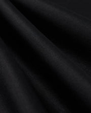 Close-up of the smooth, dark fabric of the Psycho Bunny MENS BROADWAY PIMA INTERLOCK JOHNNY COLLAR POLO - B6K891D200, with gentle folds creating subtle shadows and highlights. The Mercerized Pima cotton demonstrates a durable lustre, appearing soft and draped, showcasing its texture and depth against a dark background.