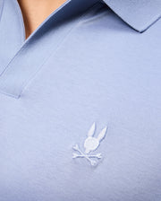 Close-up of the Psycho Bunny MENS BROADWAY MERCERIZED PIMA POLO SHIRT - B6K891D200 in light blue, made from mercerized Pima cotton for lasting shine. It has a small embroidered rabbit head with crossed bones and a ribbed collar.