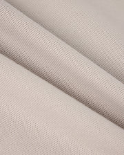 Close-up of a piece of light grey woven fabric with a fine, smooth texture. The fabric is draped to create gentle, diagonal folds, highlighting its soft and pliable nature, reminiscent of the exquisite feel found in Psycho Bunny's MENS MALTON PIQUE POLO SHIRT - B6K950D200.