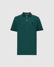 The Psycho Bunny MENS MALTON PIQUE POLO - B6K950D200 is a dark green, premium men's polo shirt featuring a collar and short sleeves. It has a small embroidered logo on the left chest and a buttoned placket with two visible buttons. Made from lightweight pique fabric, this shirt offers both comfort and style for any occasion.