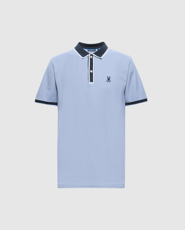 The Psycho Bunny MENS KENT PIQUE POLO - B6K951D200 is a premium men's polo shirt in light blue, featuring a navy collar and cuffs, a white button placket, and an embroidered logo on the left chest. Crafted from fine materials, it showcases delicate white trim on the collar and sleeves for added elegance.