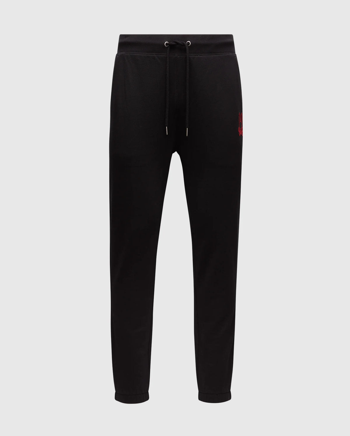 The Psycho Bunny MENS PIERCE ESSENTIAL FRENCH TERRY SWEATPANT - B6P136E200 are black sweatpants featuring a drawstring waistband and tapered legs. A small red embroidered logo is positioned on the left upper thigh, providing both style and comfort. Set against a plain white background, these joggers are an essential addition to any men's lounge collection.