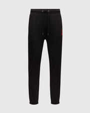 The Psycho Bunny MENS PIERCE ESSENTIAL FRENCH TERRY SWEATPANT - B6P136E200 are black sweatpants featuring a drawstring waistband and tapered legs. A small red embroidered logo is positioned on the left upper thigh, providing both style and comfort. Set against a plain white background, these joggers are an essential addition to any men's lounge collection.