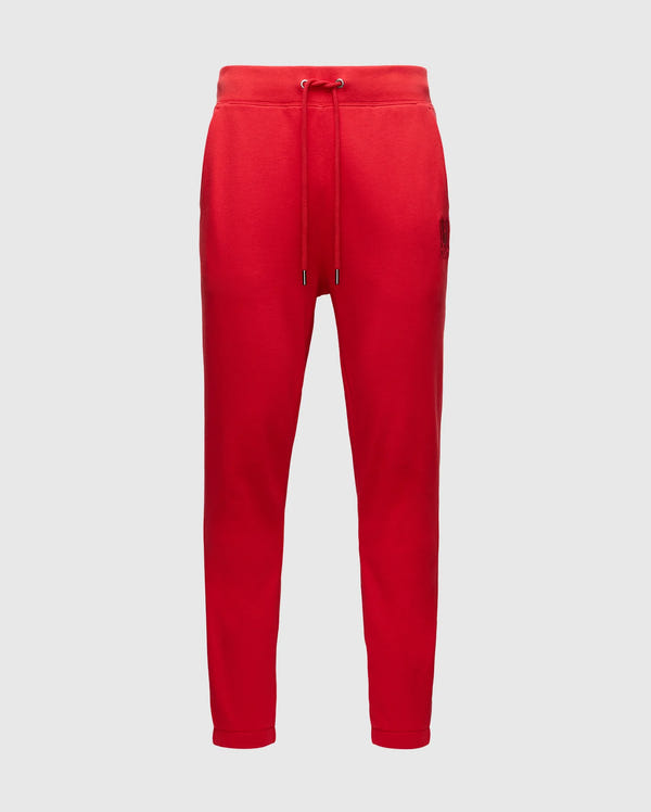 The Psycho Bunny MENS PIERCE ESSENTIAL FRENCH TERRY SWEATPANT - B6P136E200 is a red lounge pant featuring an elastic waistband with drawstring, two side pockets, and tapered legs, crafted from cotton French terry.