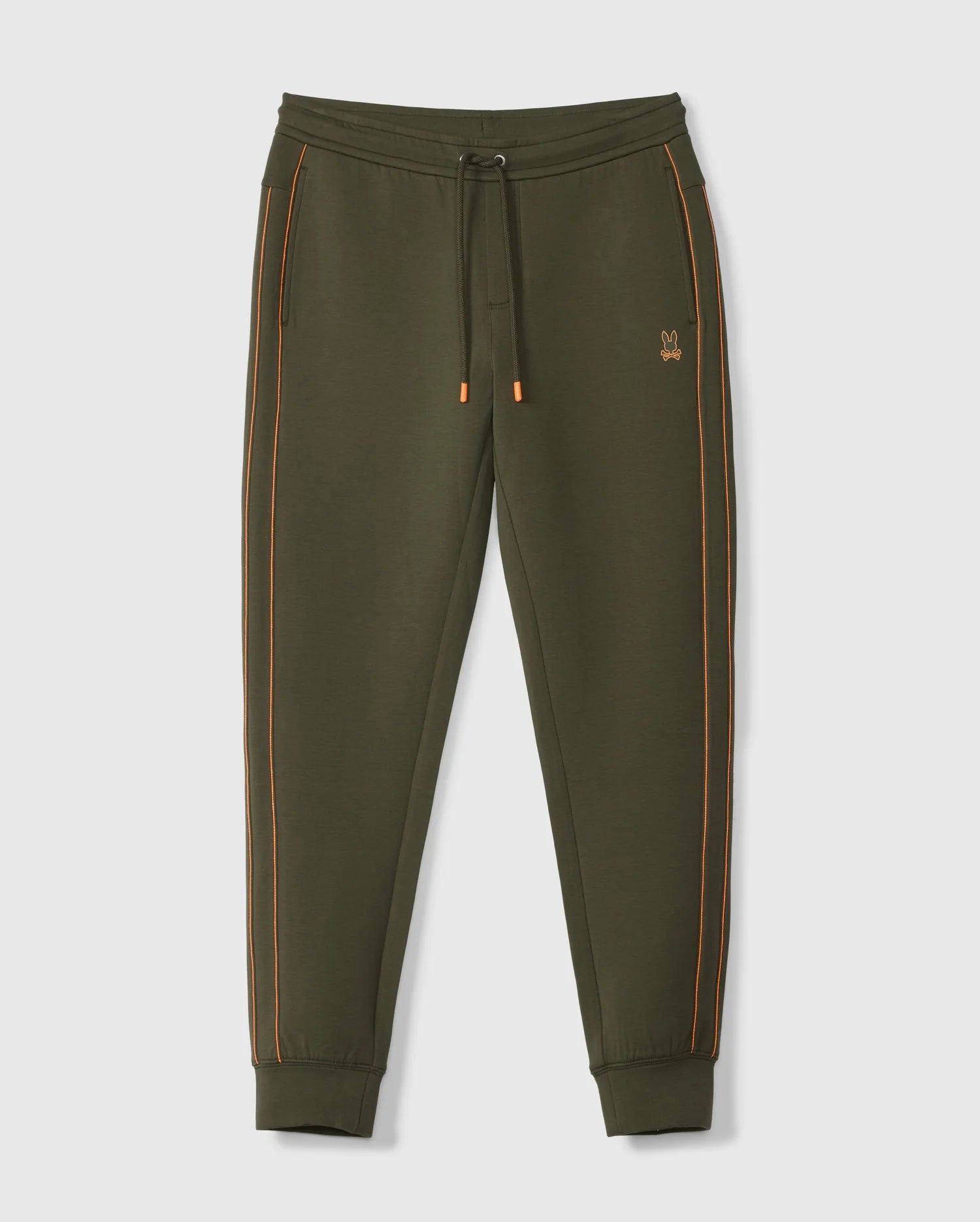 The MENS TRAVIS TRACK PANT - B6P143D200 by Psycho Bunny is crafted from a high-quality cotton blend in an olive green hue, featuring distinctive orange piping along the sides. These pants come with an elastic waistband complete with a drawstring, side invisible zip pockets, and cuffed ankles for added comfort and style. A small embroidered logo adorns the left thigh. Displayed against a plain white background.
