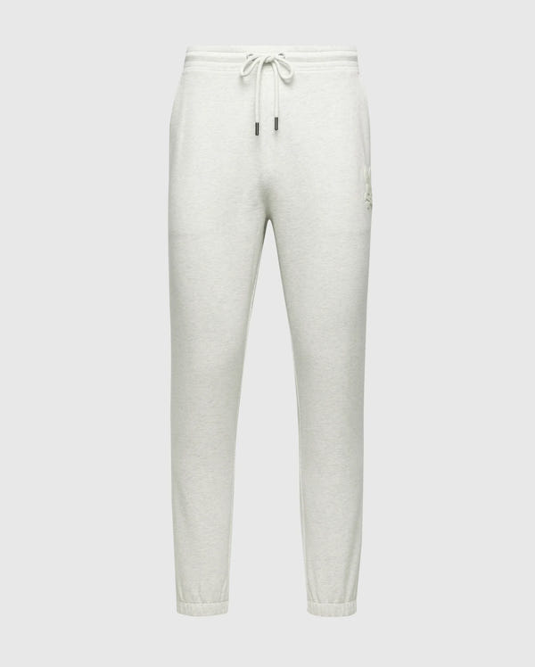 The MENS ELDORADO BRUSH BACK JOGGER - B6P285E200 by Psycho Bunny features a light gray color and the Chenille Bunny logo. These joggers have an adjustable drawstring waistband, two side pockets, and elasticized ankle cuffs. Made from soft brushback cotton for comfort.