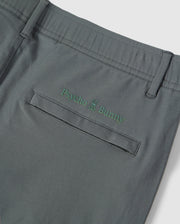 Close-up of the back pocket of Psycho Bunny's Mens Madison Commuter Pant with the embroidered Bunny logos and a small green bunny graphic above the text.