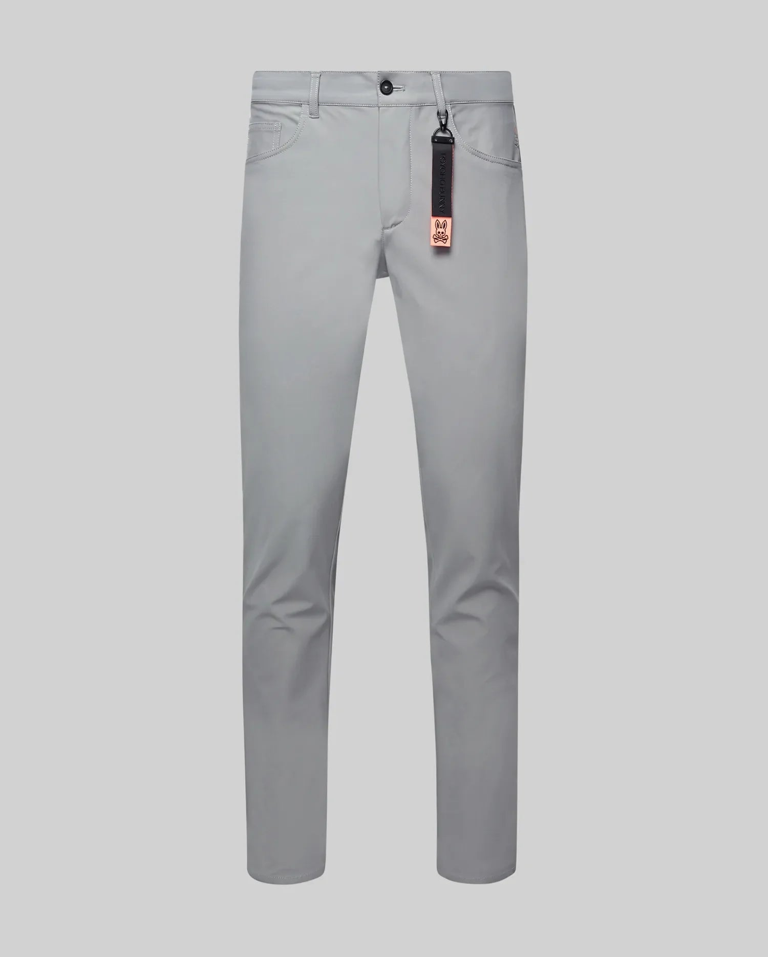 Mens Maverick 10k Step Pant in light grey, featuring a slim fit, smooth performance fabric, black button, coin pocket, and a black/orange Psycho Bunny logo keychain.