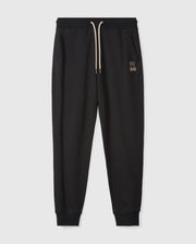The MENS JAMES PREMIUM SWEATPANT (B6P791D200) by Psycho Bunny are black cotton-blend sweatpants featuring an elastic waistband and cream drawstring, with a small rabbit logo embroidered on the left side. Designed with a tapered fit and cuffs at the ankles, these premium sweatpants are displayed against a plain white background.