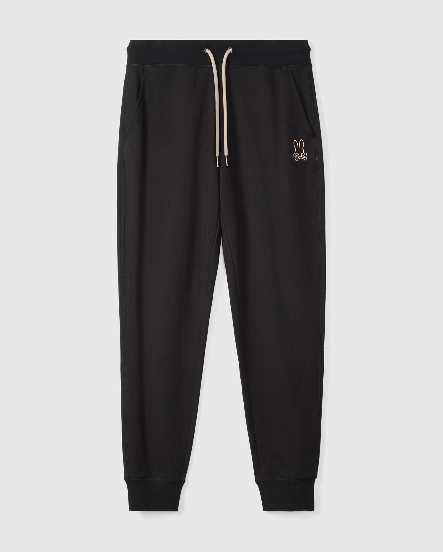 The MENS JAMES PREMIUM SWEATPANT (B6P791D200) by Psycho Bunny are black cotton-blend sweatpants featuring an elastic waistband and cream drawstring, with a small rabbit logo embroidered on the left side. Designed with a tapered fit and cuffs at the ankles, these premium sweatpants are displayed against a plain white background.