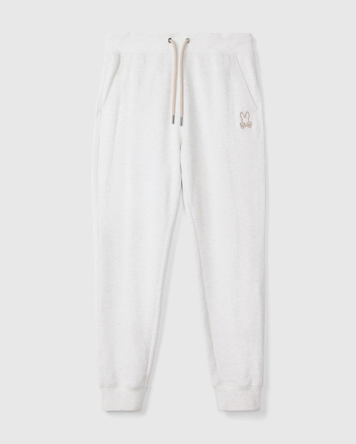 Introducing the MENS JAMES PREMIUM SWEATPANT - B6P791D200 by Psycho Bunny, a stylish pair of light gray cotton-blend sweatpants featuring an embroidered bunny logo on the left thigh. These premium bottoms showcase a relaxed fit with an elastic waistband and beige drawstrings, complemented by two side pockets, all set against a plain white background.