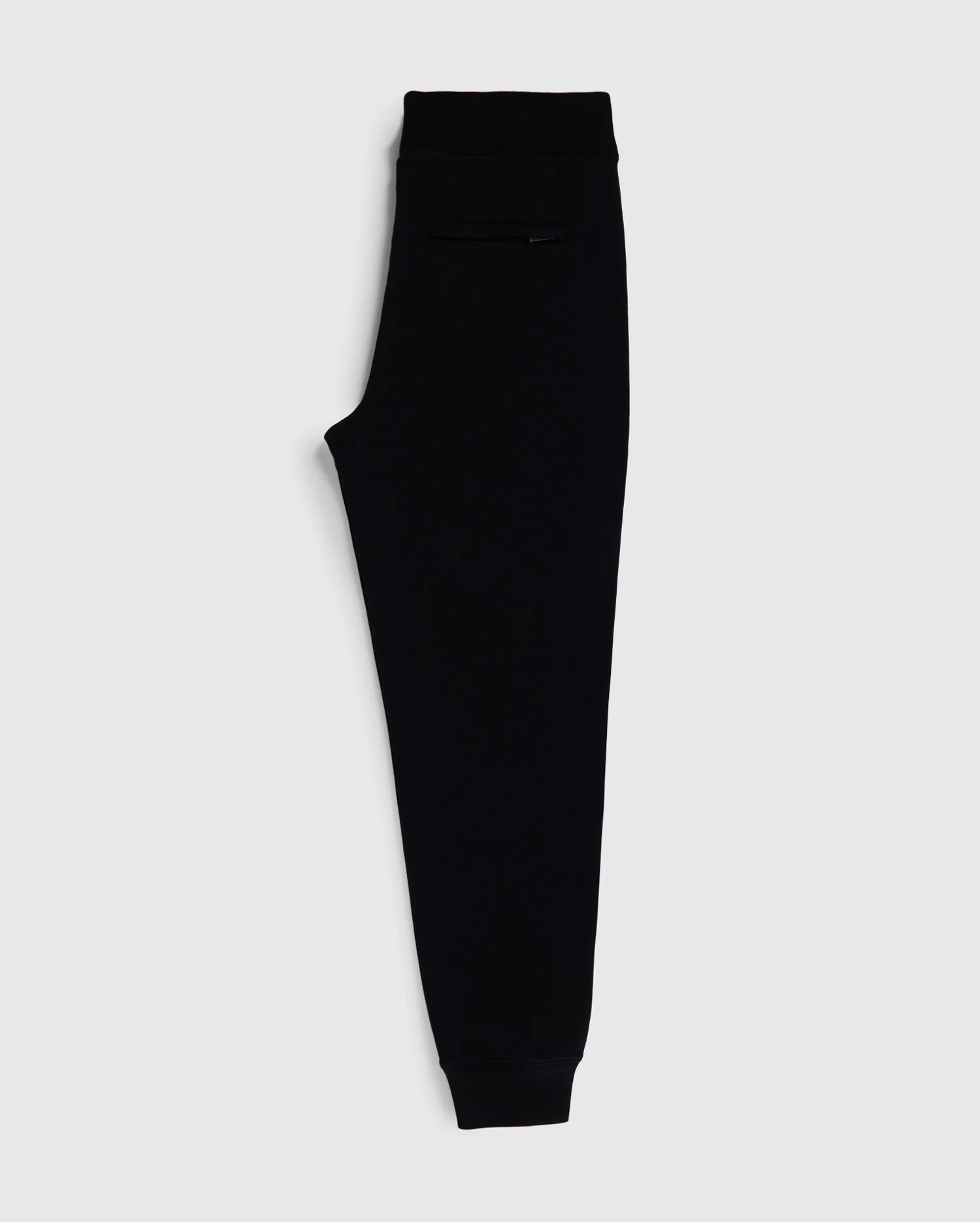 A pair of Psycho Bunny MENS SANTA CRUZ SWEATPANT - B6P843A2FT in sleek black, with an elastic waistband and cuffs, displayed on a plain white background. Made from 100% cotton for ultimate comfort and style, these sweatpants feature a minimalist design and a small pocket on the side near the waistband.