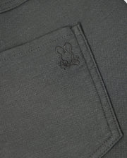 Here's a detailed look at the pocket of the MENS HAYS TWILL PANT - B6P894D200 by Psycho Bunny. The dark grey, regular fit fabric pocket features an embroidered design of a bunny's head and crossed bones. The subtle stitching complements the cotton-blend twill material, which offers 4-way stretch for enhanced comfort and style.