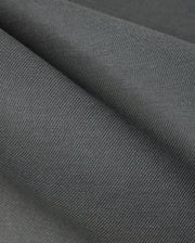 Close-up of the textured dark gray cotton-blend twill fabric from the Psycho Bunny MENS HAYS TWILL PANT - B6P894D200, featuring soft folds and a slightly ribbed pattern, highlighting its smooth surface and subtle color variations.