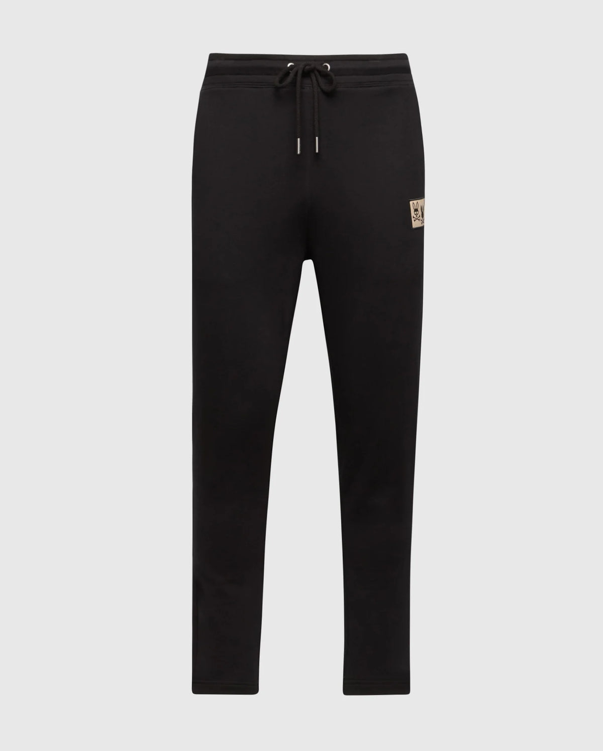 The MENS MONROE TWILL PATCH FLEECE SWEATPANT by Psycho Bunny, in black, features a soft French terry construction and an adjustable drawstring waistband. A small logo patch on the left thigh adds a subtle touch of style. These sweatpants are showcased against a plain, light grey background.