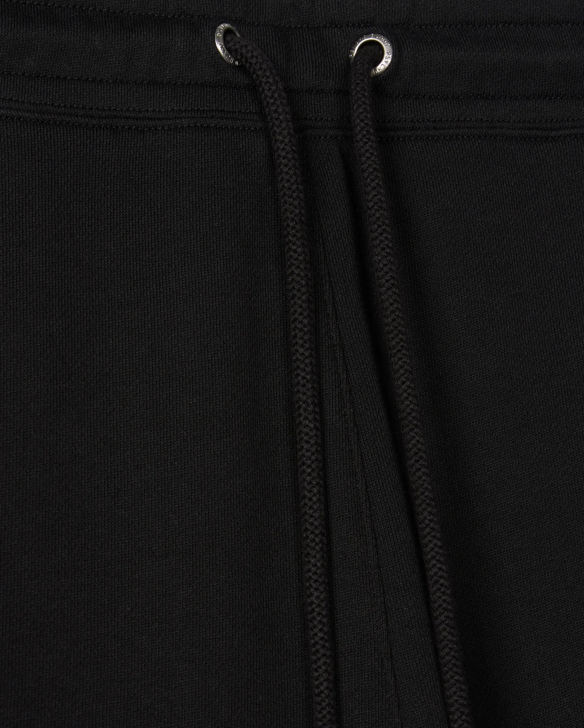 Close-up view of the black Psycho Bunny MENS PACIFIC CHENILLE JOGGER - B6P972D200, highlighting a drawstring with metal eyelets. The fabric texture is clearly visible, accentuating the casual design of these stylish bottoms.