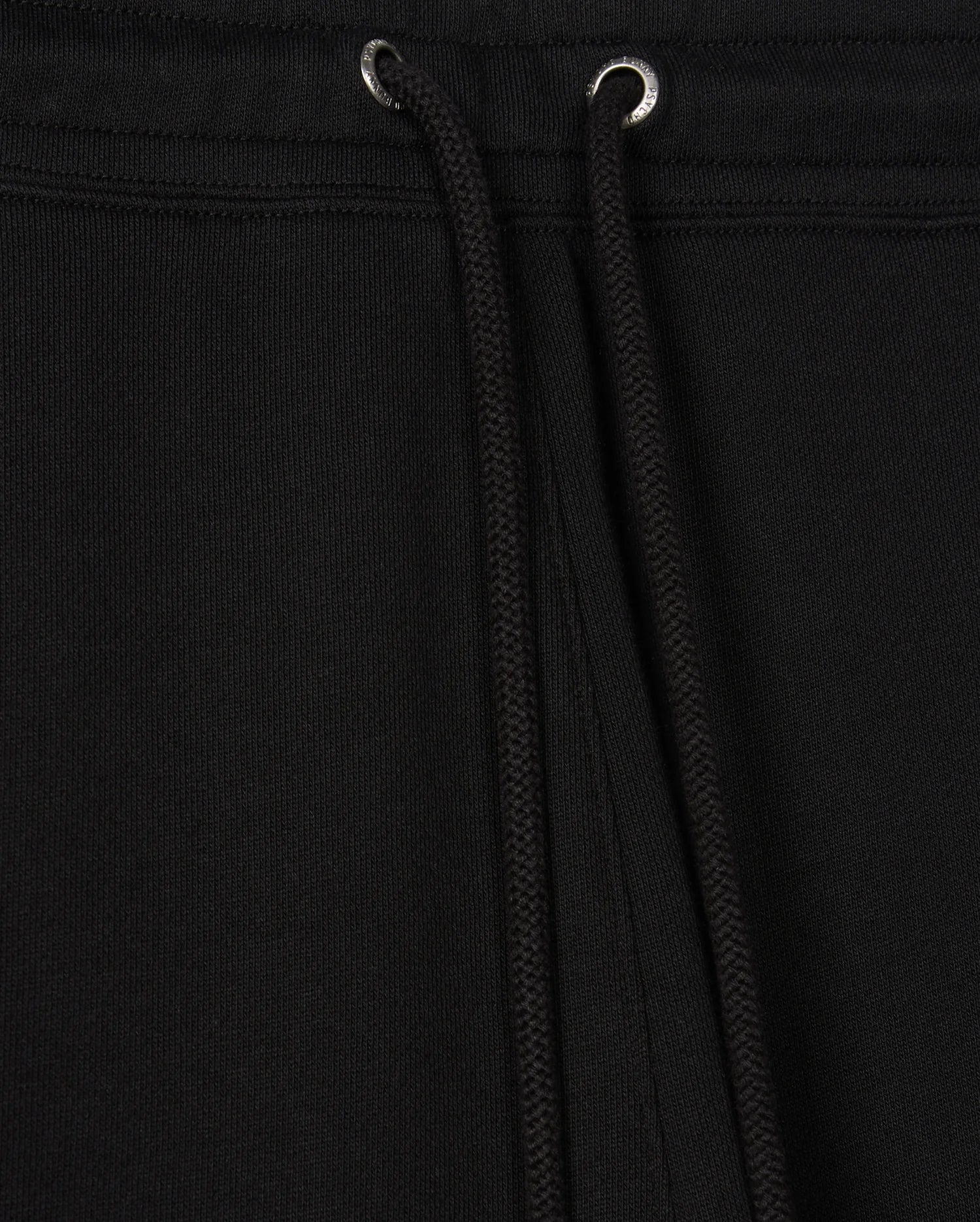 Close-up view of the black Psycho Bunny MENS PACIFIC CHENILLE JOGGER - B6P972D200, highlighting a drawstring with metal eyelets. The fabric texture is clearly visible, accentuating the casual design of these stylish bottoms.