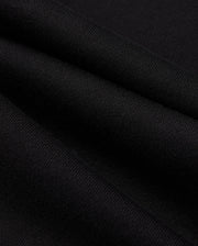 A close-up of the black fabric reveals a fine, smooth texture and gentle folds, showcasing its intricate weave pattern reminiscent of the Psycho Bunny Mens Pacific Chenille Jogger - B6P972D200.