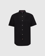The Psycho Bunny MENS GABRIEL SHORT SLEEVE SHIRT (B6Q351F200) is a black woven stretch button-up with white buttons, an embroidered logo on the left chest, pink detailing on the inner collar, and a slightly curved classic hem for timeless style.