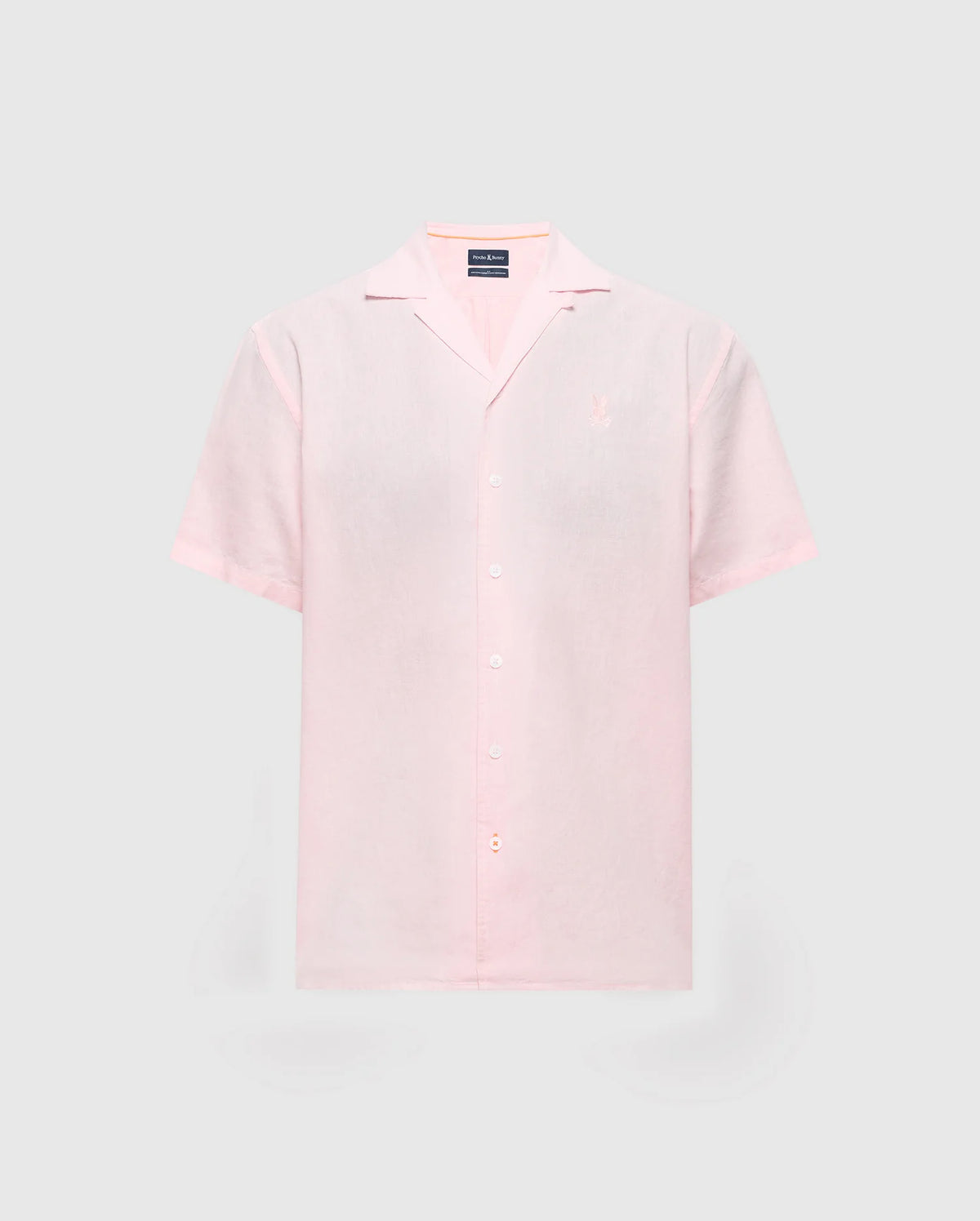Light pink MENS COBAR WOVEN SHIRT by Psycho Bunny with short sleeves and a notched collar on a gray background. Made from a linen blend, it includes an embroidered logo on the left chest. Model: B6Q522F200.