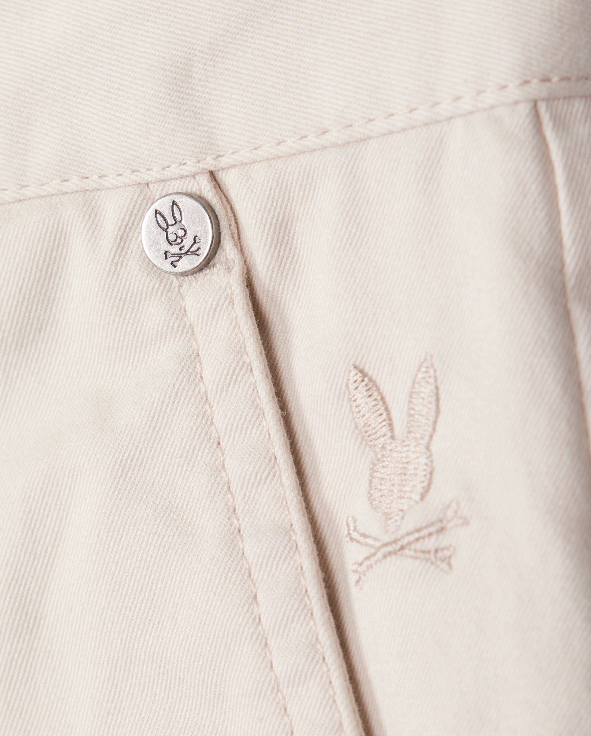 A button on a white shirt, perfect for pairing with Psycho Bunny's MENS YORK CHINO SHORT - B6R357B200.