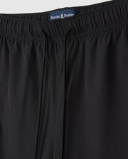 A close-up of a pair of black MENS SONTERRA STRIPE SPORT SHORT - B6R464C200 by Psycho Bunny made from quick-drying, breathable fabric.