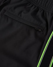 Close-up image of black athletic pants made from breathable fabric, showing a zippered back pocket detail and a green stripe running along the side. The waistband appears elastic, providing a comfortable fit. This is the MENS SONTERRA STRIPE SPORT SHORT - B6R464C200 by Psycho Bunny.