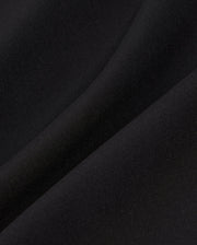 Close-up of a smooth, black fabric showing subtle light reflections and a gentle fold. The texture appears soft and even, indicating a fine, high-quality material often used in the Psycho Bunny MENS SONTERRA STRIPE SPORT SHORT - B6R464C200 for its quick-drying and breathable properties.