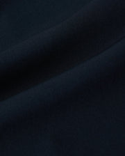 Close-up of dark blue fabric with soft, smooth texture and gentle folds. The material appears to be finely woven, creating a uniform and seamless appearance. Its quick-drying properties make it ideal for the Psycho Bunny MENS SONTERRA STRIPE SPORT SHORT - B6R464C200.