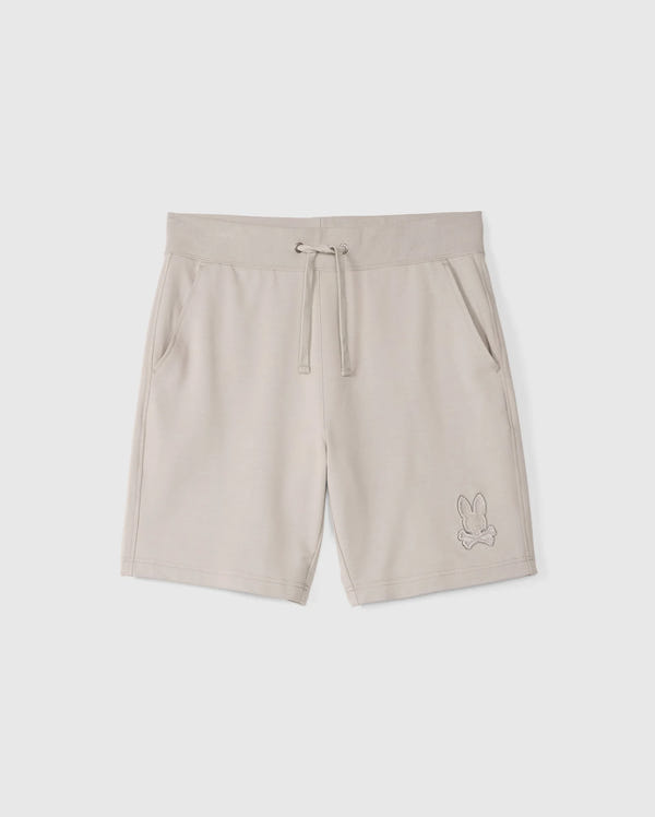 The MENS WALTER LIGHTWEIGHT SWEATSHORT - B6R477D200 by Psycho Bunny are beige, high-quality cotton blend shorts with an elastic waistband, drawstring, and side pockets. They feature an embroidered outline of a rabbit on the lower left leg and offer a regular fit for all-day comfort.