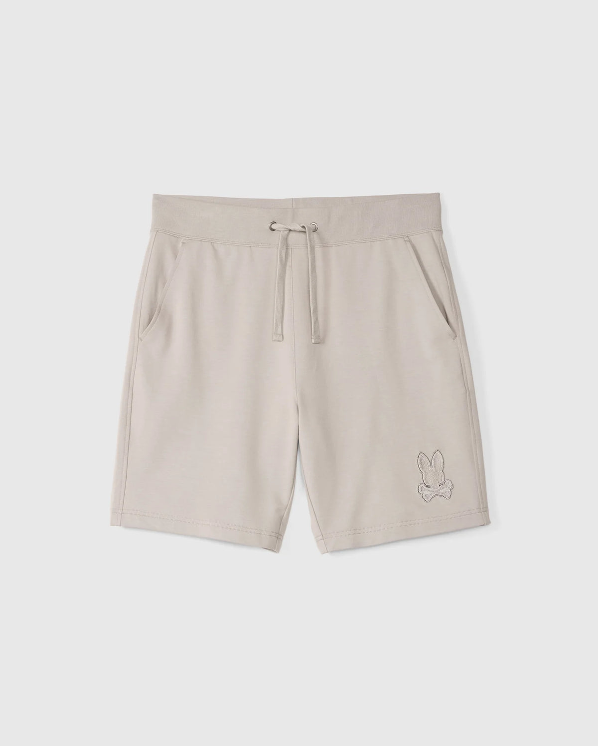 The MENS WALTER LIGHTWEIGHT SWEATSHORT - B6R477D200 by Psycho Bunny are beige, high-quality cotton blend shorts with an elastic waistband, drawstring, and side pockets. They feature an embroidered outline of a rabbit on the lower left leg and offer a regular fit for all-day comfort.