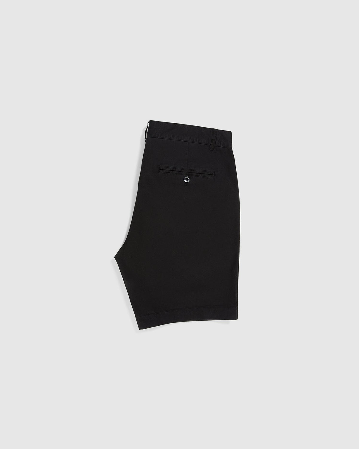 A pair of Psycho Bunny MENS HAYDEN SHORT - B6R757ARCE in black with a single back pocket featuring a button closure. Made from breathable cotton, these slim fit shorts have belt loops and a zip fly with a button closure at the waist. The design is simple and classic, suitable for casual wear against a plain light gray background.
