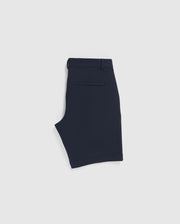 A pair of Psycho Bunny MENS GABLE REGULAR FIT SPORT SHORT - B6R761ARCN is folded flat and viewed from the side, showcasing the waistband, a belt loop, and a single back pocket with a horizontal slit design. Made from durable stretch cotton-nylon, these shorts also feature a hidden zip pocket for added functionality. The shorts have a clean, minimalist appearance.