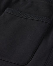 Close-up of the Psycho Bunny MENS LEVY FLEECE SWEATSHORT - B6R862D200 in black cotton, showcasing a detailed pocket with ribbed edges. The visible stitching highlights the texture and craftsmanship that ensures everyday comfort.