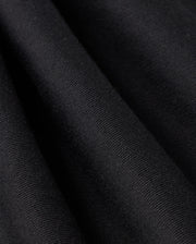 Close-up view of a black fabric with fine, visible texture and folds creating subtle shadows and highlights, depicting the material's softness and smooth surface—ideal for Psycho Bunny's MENS LEVY FLEECE SWEATSHORT - B6R862D200.