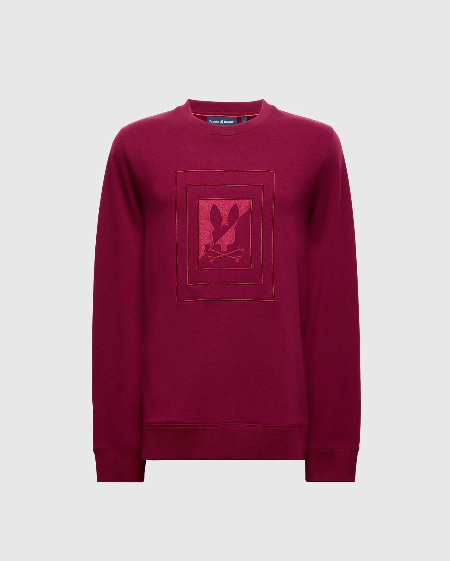 This high-quality maroon "Mens Oak City Crew Neck - B6S274E200" by Psycho Bunny showcases a rectangular graphic with a stylized rabbit logo in the center, highlighted by raised embroidery for added texture and an enhanced style.