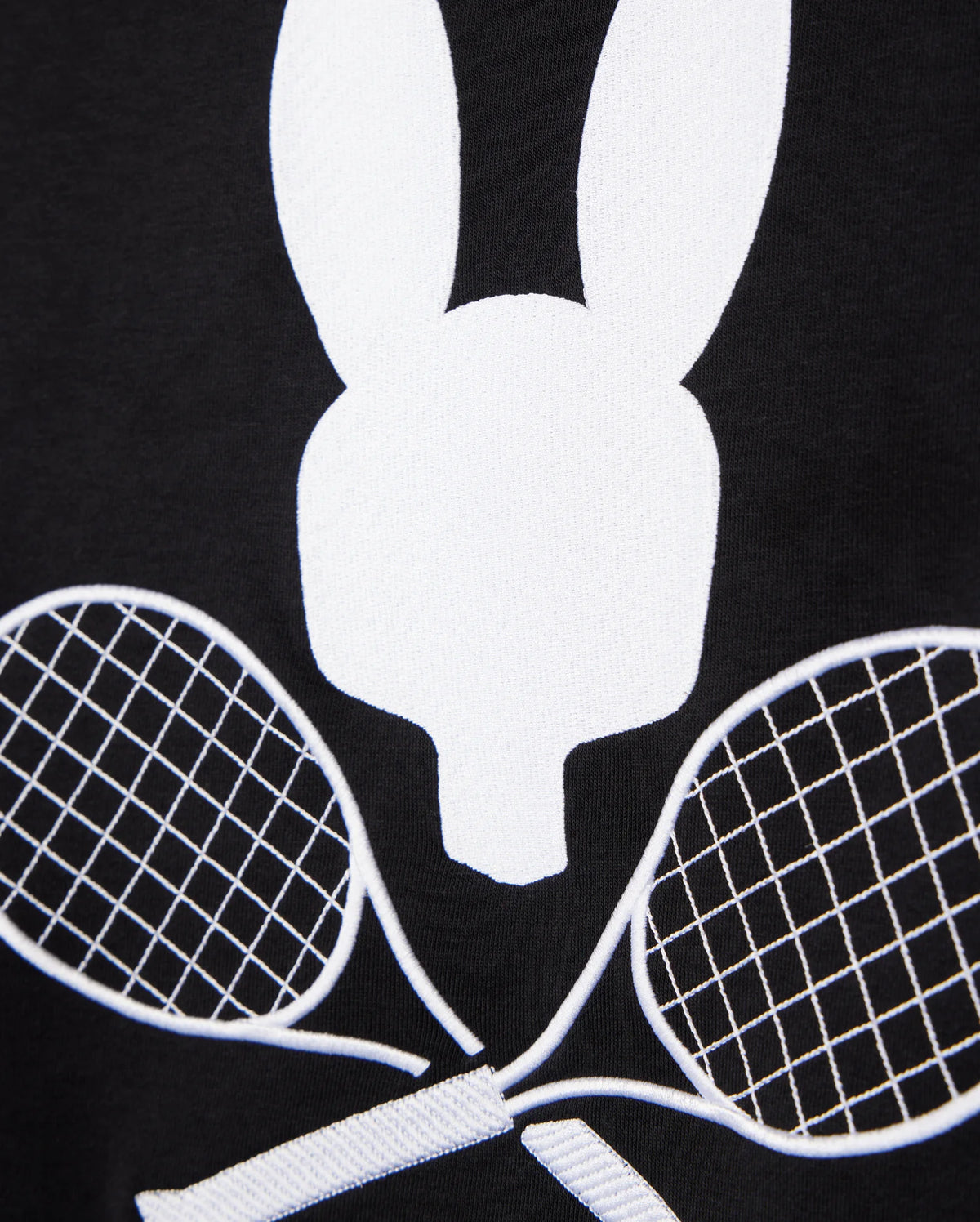 A black background showcases a white minimalist rabbit head graphic above two crisscrossed tennis rackets, creating a tennis-inspired aesthetic. This design perfectly embodies the sporty sophistication of the MENS COURTSIDE SWEATSHIRT - B6S688C200 by Psycho Bunny, crafted for style and comfort from breathable cotton-blend fabric.