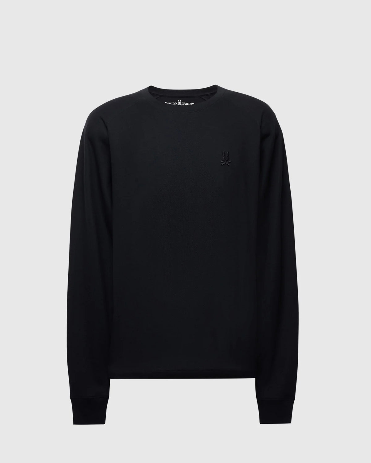 The Psycho Bunny MENS TAYLOR PIQUE LONG SLEEVE TEE, crafted from Pima cotton, in black with long sleeves and a small embroidered Bunny logo on the left chest, is displayed on a light gray background.