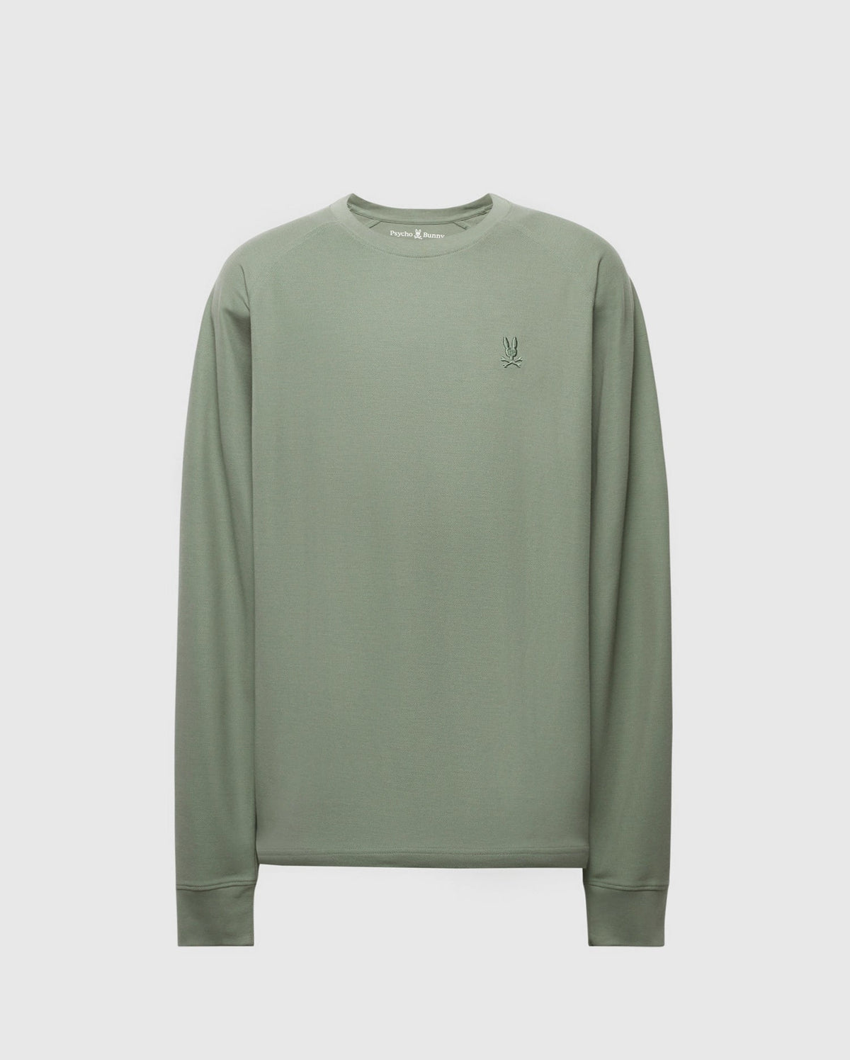 The Psycho Bunny Men's Taylor Pique Long Sleeve Tee (B6T580F200) in light green features a crew neck, piqué knit, and ribbed cuffs. It boasts a small contrasting embroidered logo on the chest for stylish comfort.