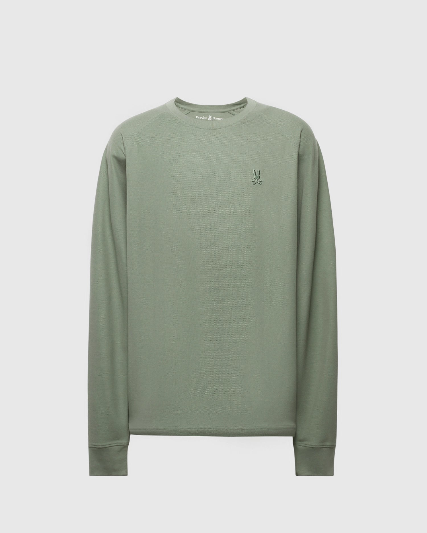 The Psycho Bunny Men's Taylor Pique Long Sleeve Tee (B6T580F200) in light green features a crew neck, piqué knit, and ribbed cuffs. It boasts a small contrasting embroidered logo on the chest for stylish comfort.