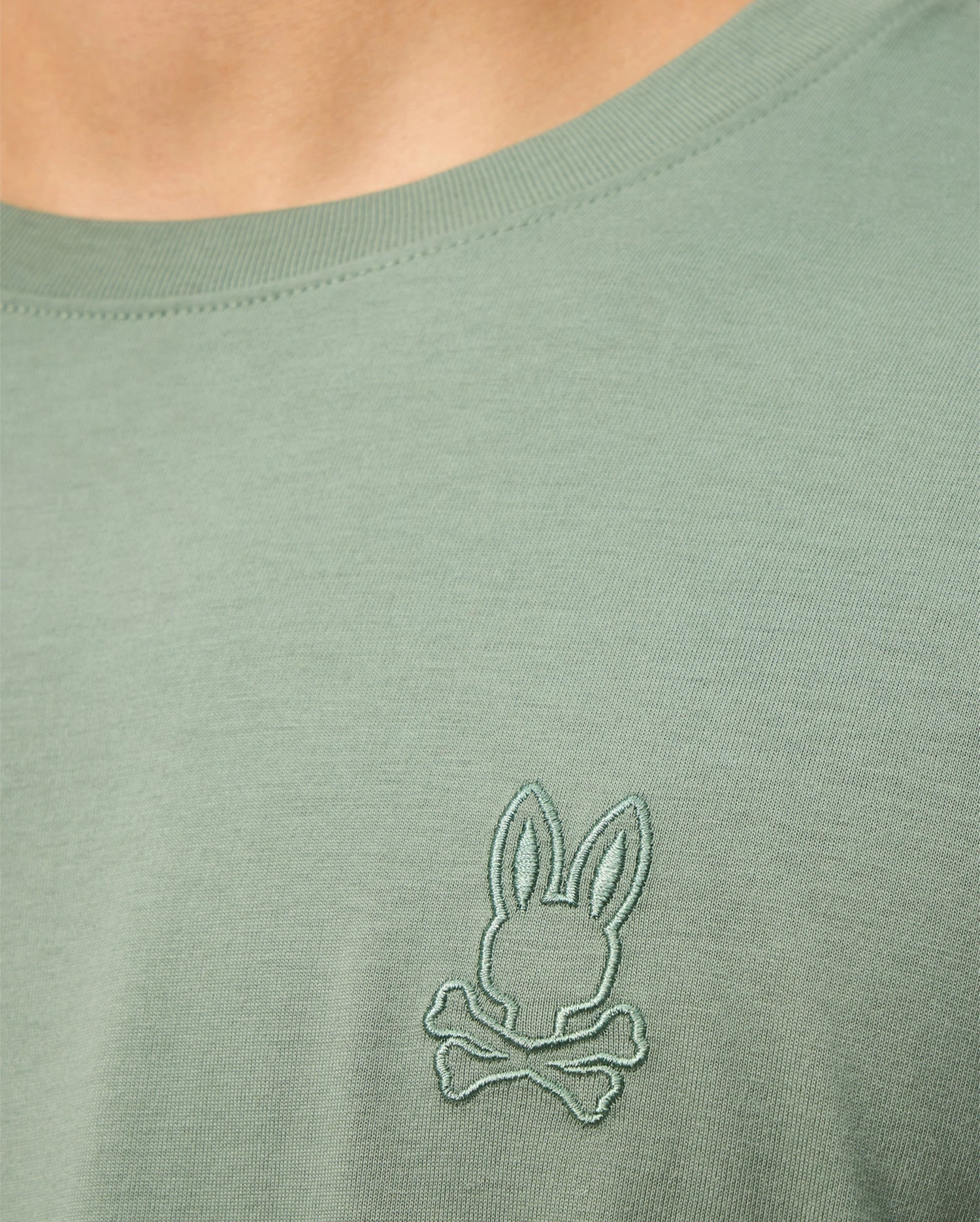 Get a closer look at the MENS ALBERTON LONG SLEEVE TEE - B6T867D200 by Psycho Bunny, crafted from luxurious Pima cotton. It showcases an embroidered bunny head logo with crossed bones on the chest.