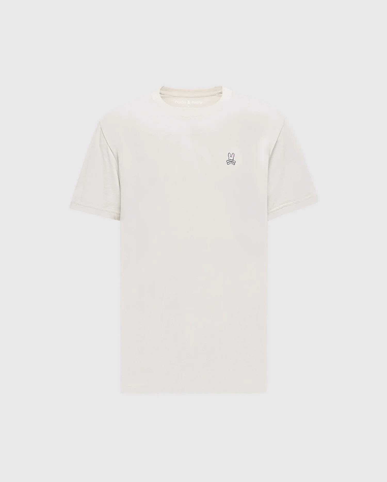 The Psycho Bunny Men's Classic Crew Neck Tee (B6U014B200) in light beige is a premium Pima cotton shirt with short sleeves and an embroidered bunny logo on the upper left chest. Set against a simple white background, it embodies timeless appeal.