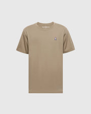 The Psycho Bunny Men's Classic Crew Neck Tee (B6U014CRPC) is a wardrobe essential made from 100% Pima cotton in beige, featuring a purple and white embroidered bunny logo on the left chest and a matching beige rib-knit trim for style.