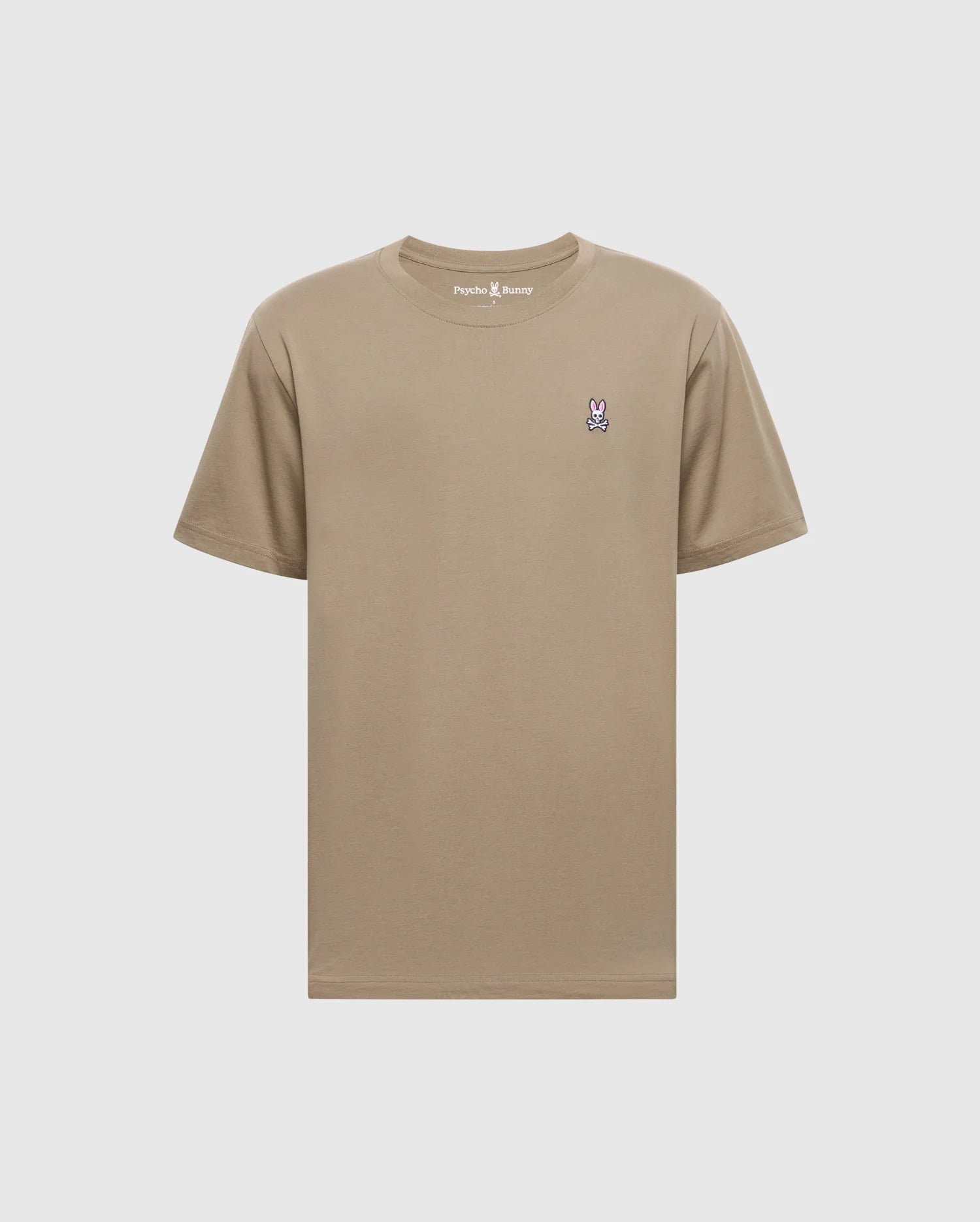 The Psycho Bunny Men's Classic Crew Neck Tee (B6U014CRPC) is a wardrobe essential made from 100% Pima cotton in beige, featuring a purple and white embroidered bunny logo on the left chest and a matching beige rib-knit trim for style.