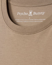 Close-up of the men's MENS CLASSIC CREW NECK TEE - B6U014CRPC in khaki, showcasing the distinctive Psycho Bunny embroidered logo along with text inside the collar. Crafted from 100% Pima cotton in Peru, this t-shirt delivers exceptional comfort and style.